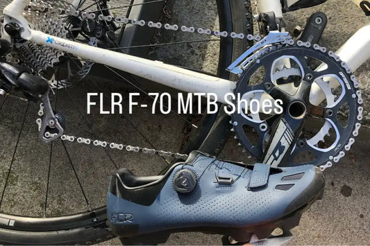 FLR F-70 MTB cycling shoe beside a mountain bike drivetrain