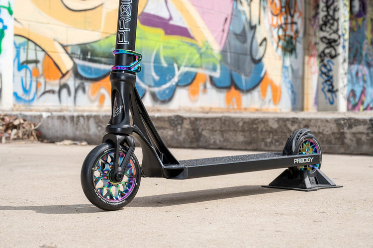 Close-up of Prodigy freestyle scooter with rainbow-core wheels