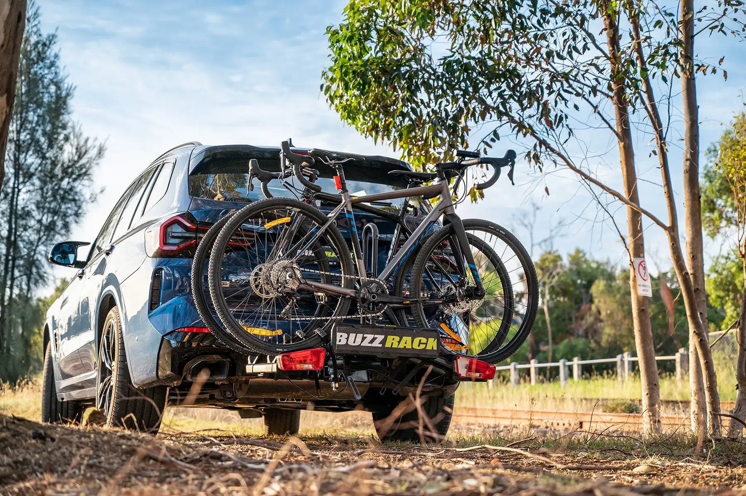 Buzz Rack hitch bike rack on a blue SUV carrying two gravel bikes outdoors